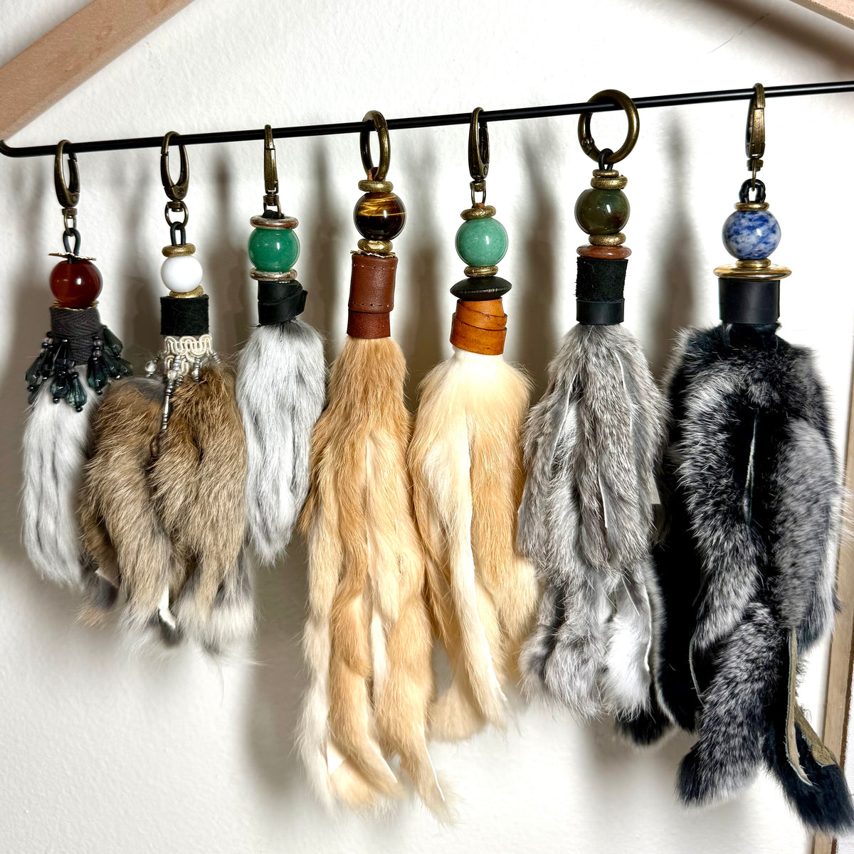 Handcrafted fur bag charm with semiprecious stones and leather detailing by Chasing Sunsets Design.