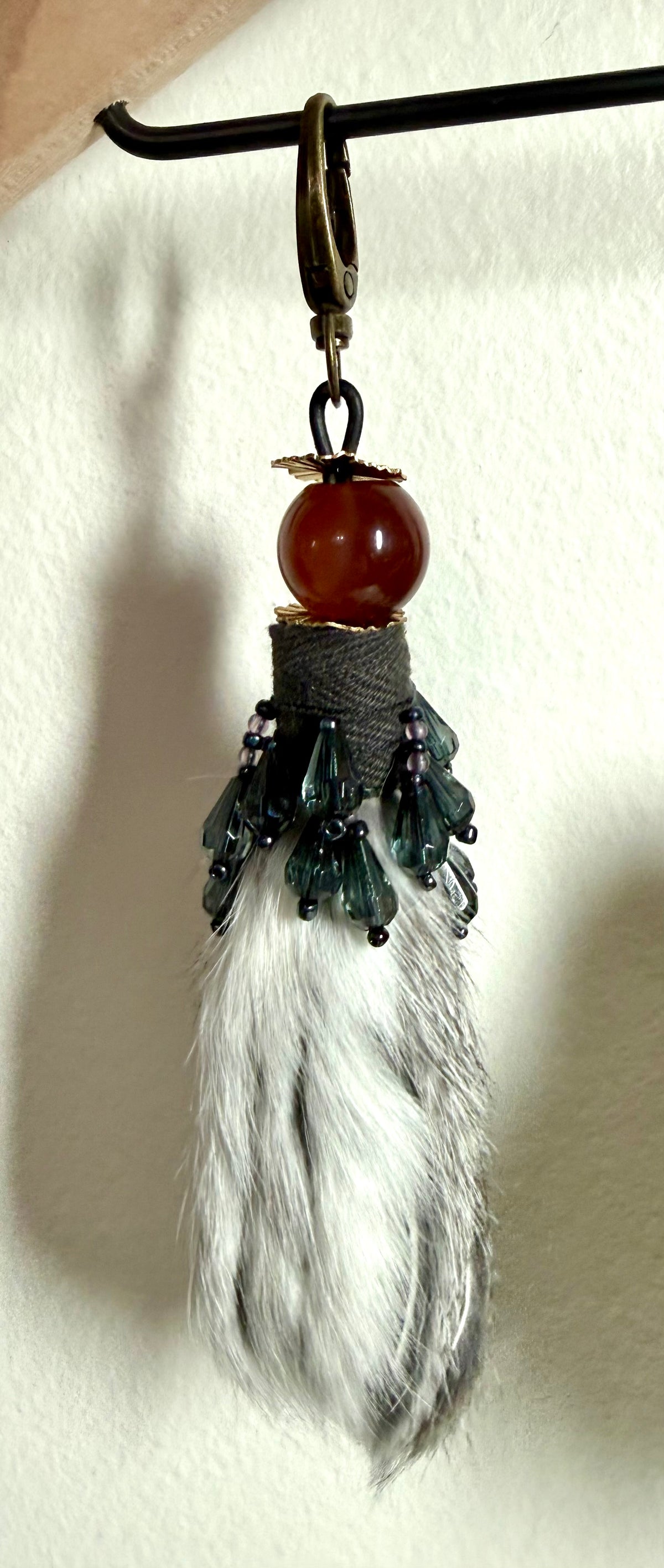 Handcrafted fur bag charm with Carnelian semiprecious stone and leather detailing by Chasing Sunsets Design.
