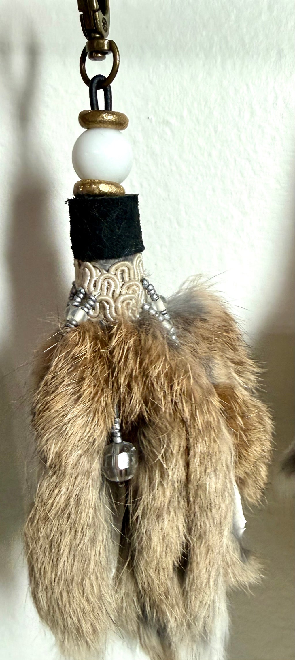 Handcrafted fur bag charm with white quartz stones vintage crystal trim  and leather detailing by Chasing Sunsets Design.