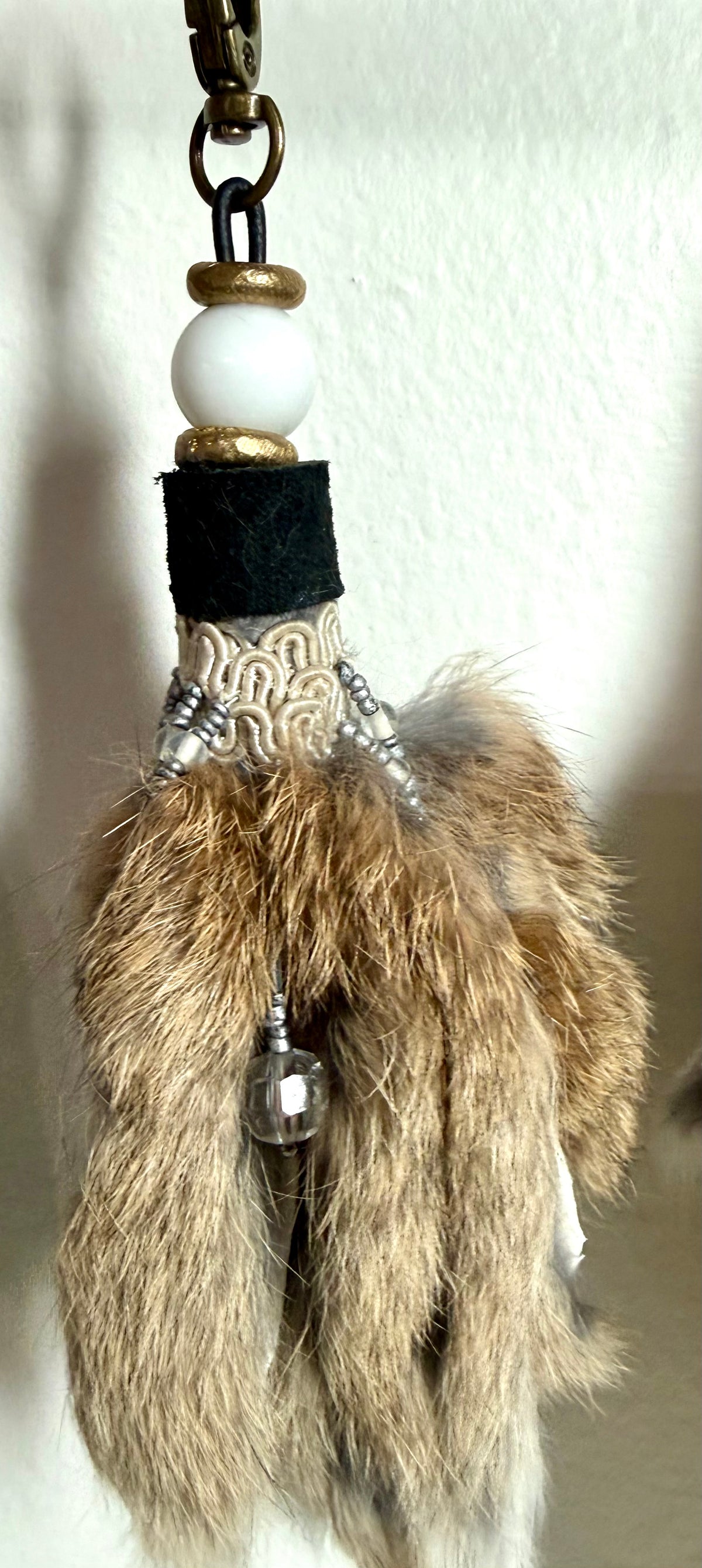 Handcrafted fur bag charm with white quartz stones vintage crystal trim  and leather detailing by Chasing Sunsets Design.
