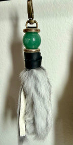 Handcrafted grey fur bag charm with jade semiprecious stones and leather detailing by Chasing Sunsets Design.