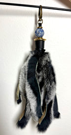 Handcrafted black fur bag charm with sodalite semiprecious stones and leather detailing by Chasing Sunsets Design.