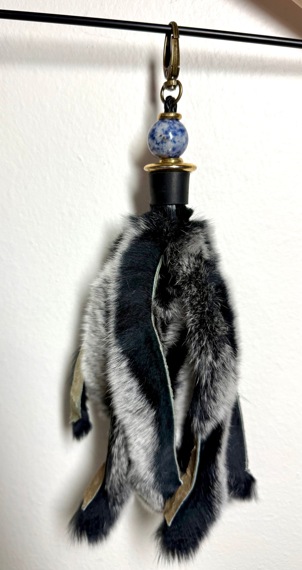 Handcrafted black fur bag charm with sodalite semiprecious stones and leather detailing by Chasing Sunsets Design.